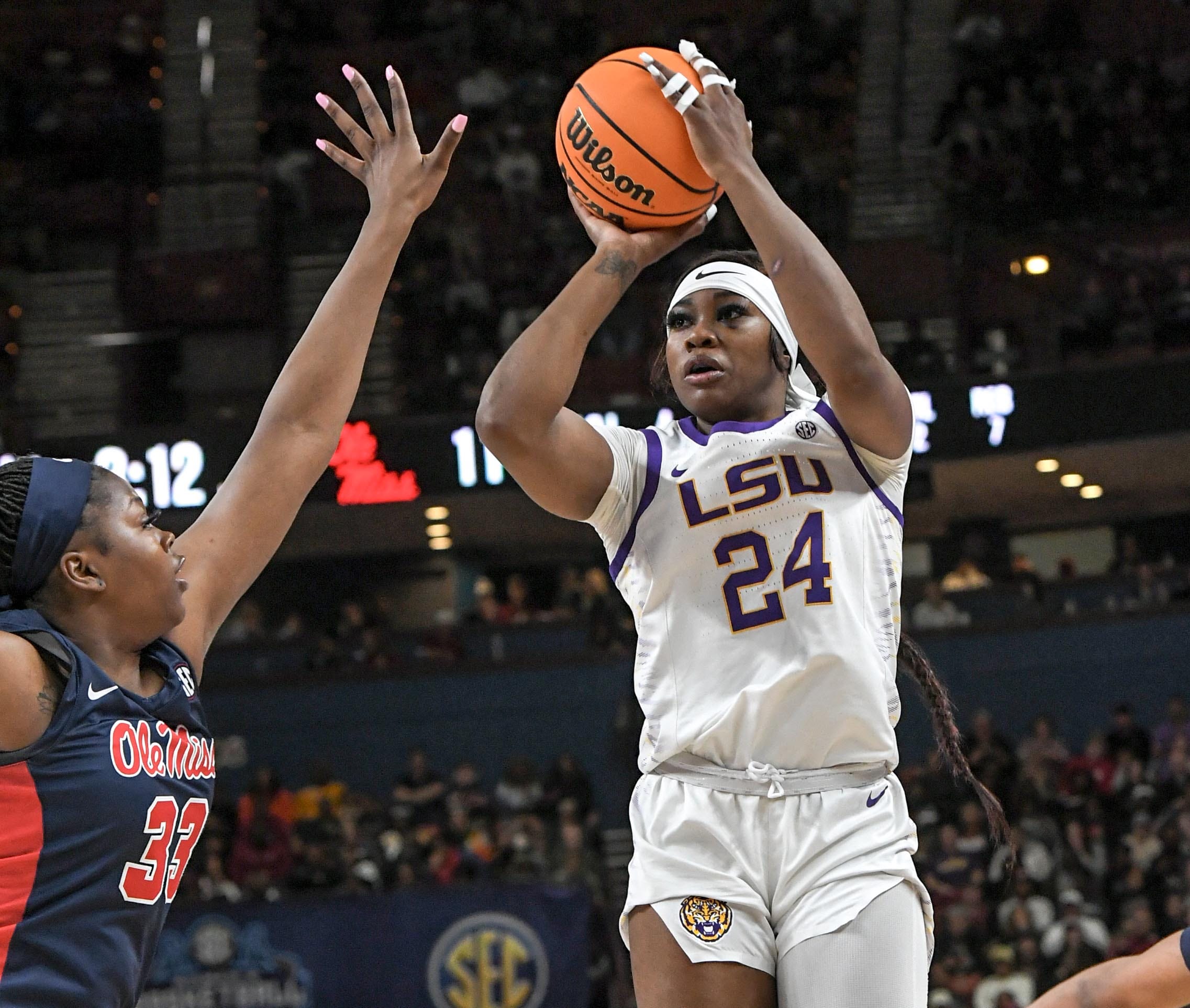 Louisiana State University guard Aneesah Morrow (24) shoots the ball near Ole Miss forward Kharyssa Richardson (33) during the first quarter of the SEC Women's Basketball Tournament game at the Bon Secours Wellness Arena in Greenville, S.C. Saturday, March 9, 2024.
