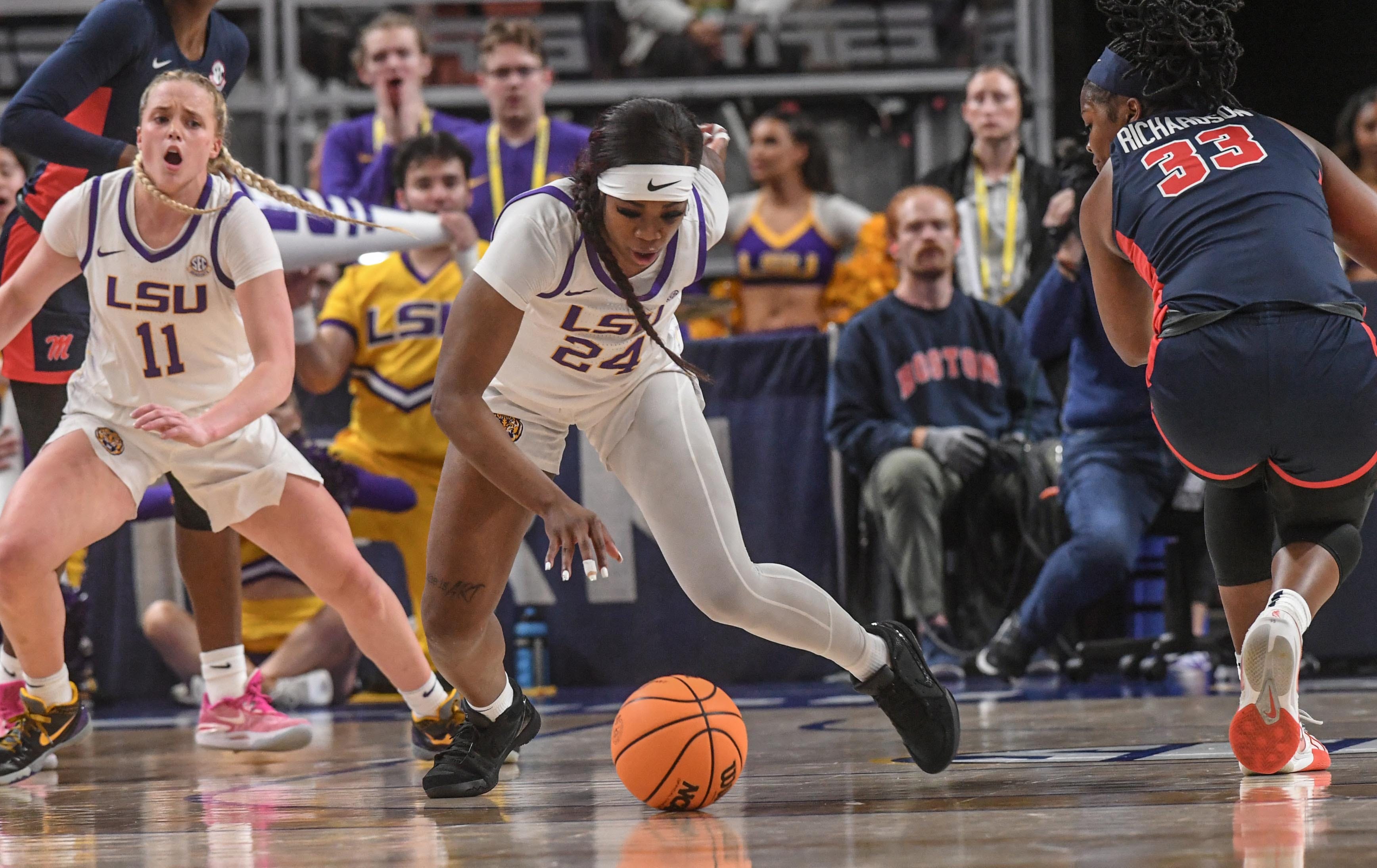 Louisiana State University guard Aneesah Morrow (24) gets a loose ball near Ole Miss forward Kharyssa Richardson (33) during the first quarter of the SEC Women's Basketball Tournament game at the Bon Secours Wellness Arena in Greenville, S.C. Saturday, March 9, 2024.