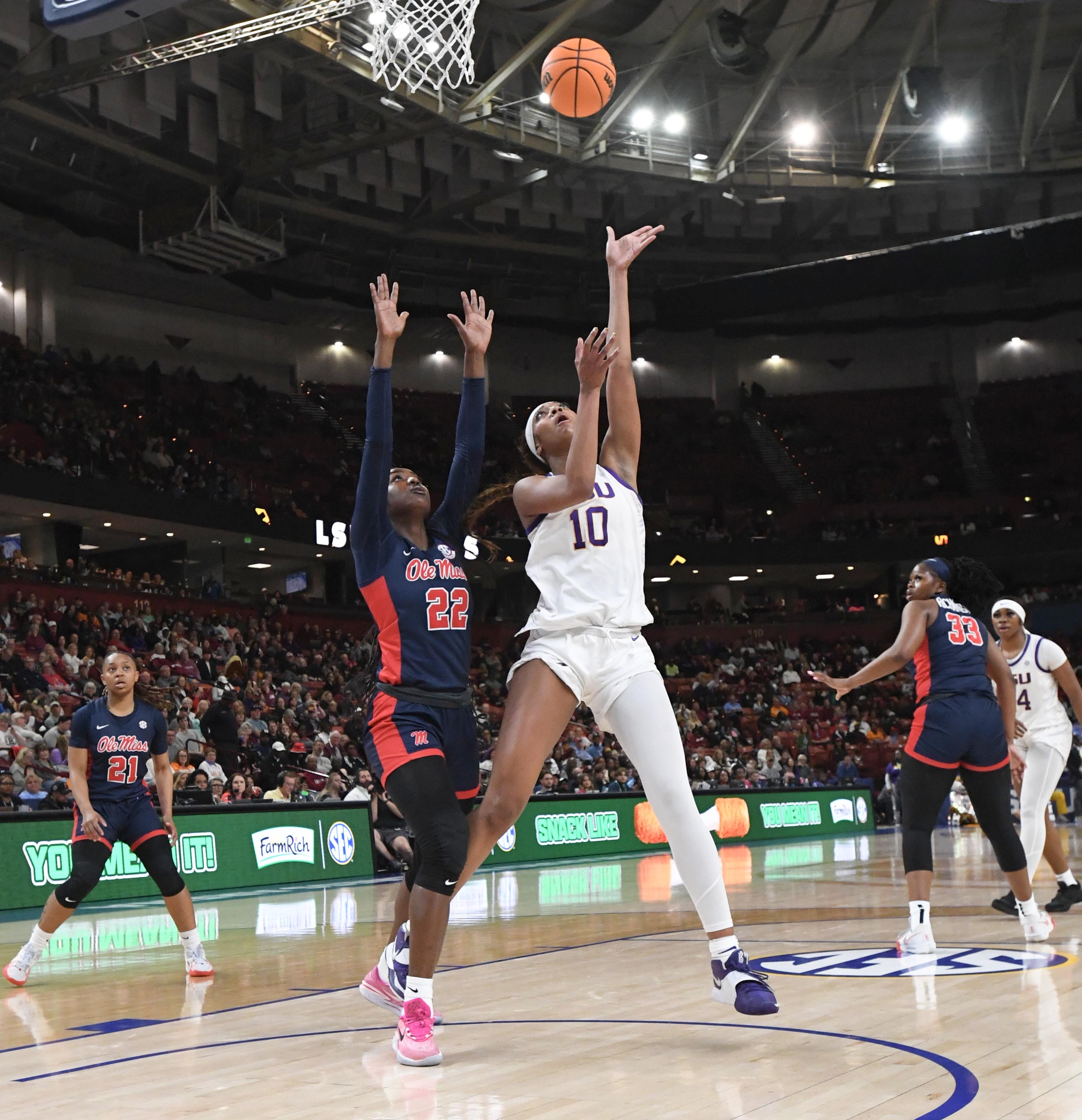 Louisiana State University forward Angel Reese (10) scores near Ole Miss forward Tyra Singleton (22) during the first quarter of the SEC Women's Basketball Tournament game at the Bon Secours Wellness Arena in Greenville, S.C. Saturday, March 9, 2024.