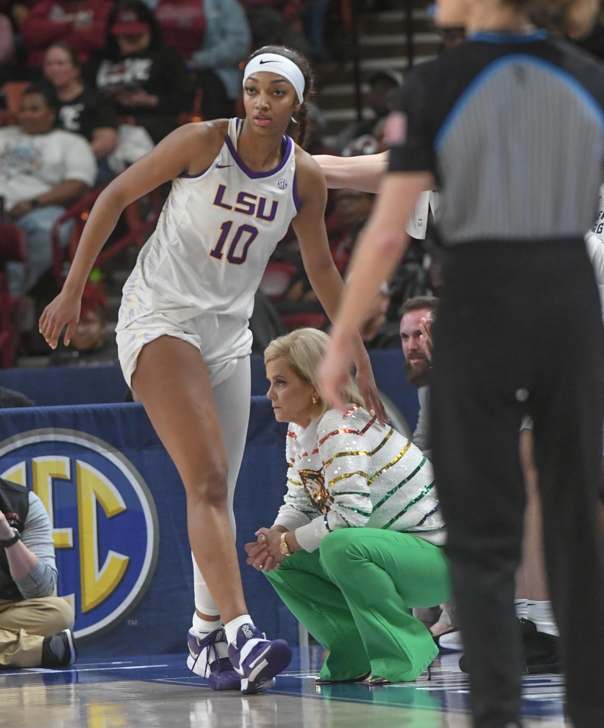 Louisiana State University forward Angel Reese (10) taps Louisiana State University Coach Kim Mulkey on the back walking by her during the second quarter of the SEC Women's Basketball Tournament game with Ole Miss at the Bon Secours Wellness Arena in Greenville, S.C. Saturday, March 9, 2024.