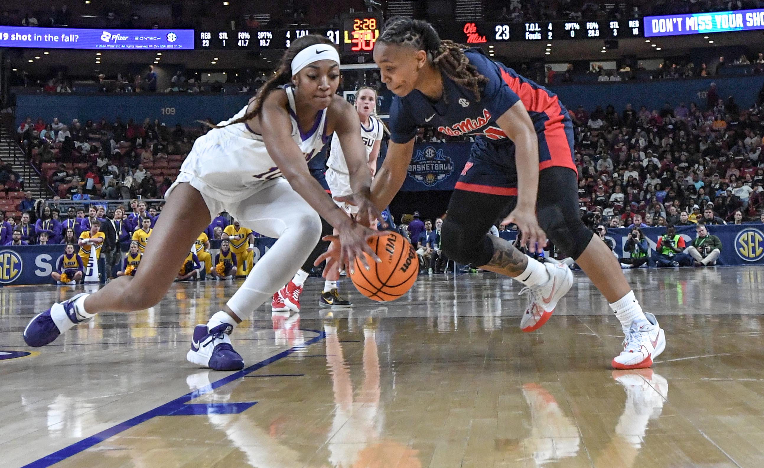 Louisiana State University forward Angel Reese (10) grabs a loose ball near Ole Miss guard Zakiya Stephenson (21) during the second quarter of the SEC Women's Basketball Tournament game at the Bon Secours Wellness Arena in Greenville, S.C. Saturday, March 9, 2024.