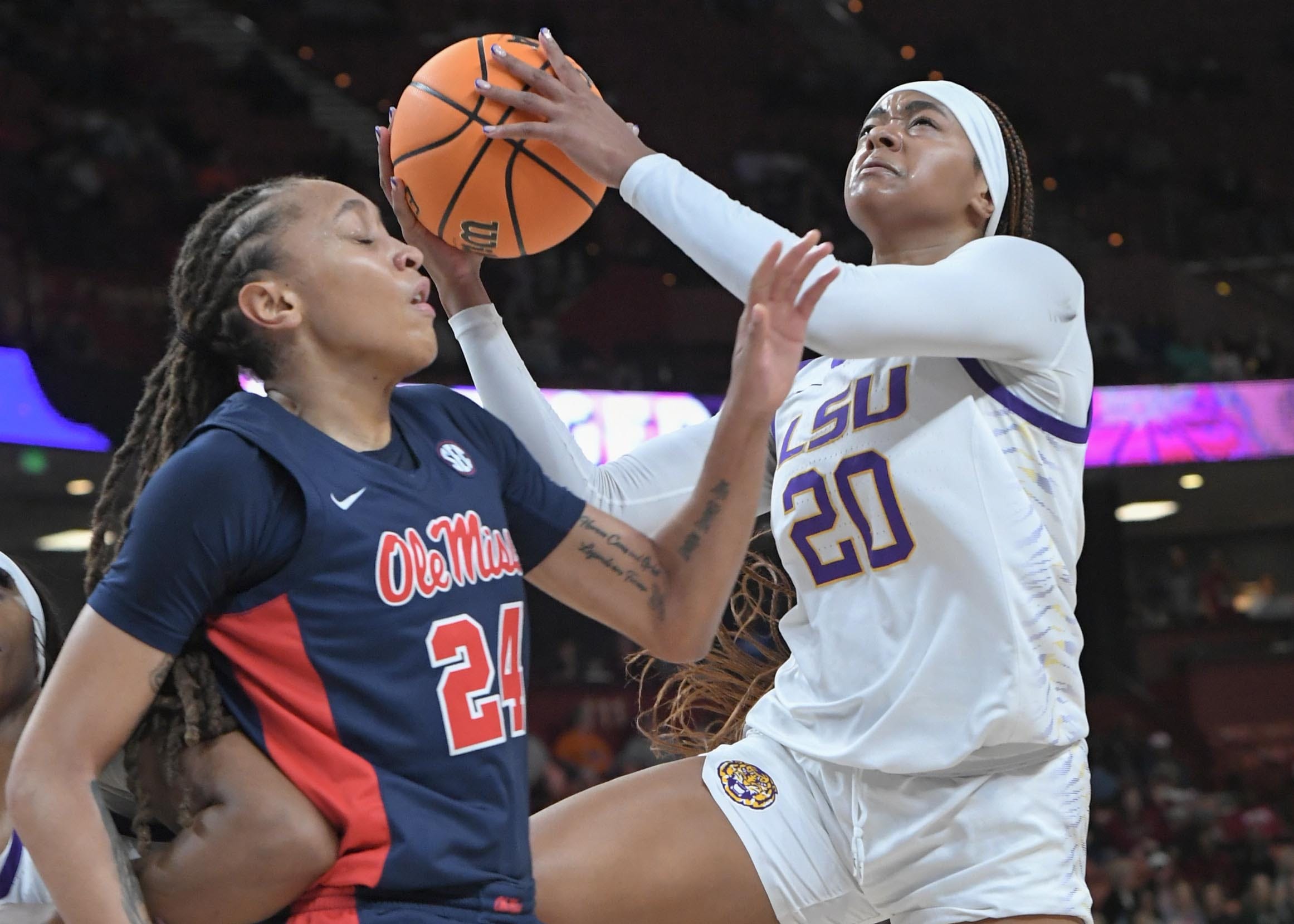 Louisiana State University guard Janae Kent (20) shoots the ball near Ole Miss Madison Scott (24) during the second quarter of the SEC Women's Basketball Tournament game at the Bon Secours Wellness Arena in Greenville, S.C. Saturday, March 9, 2024.