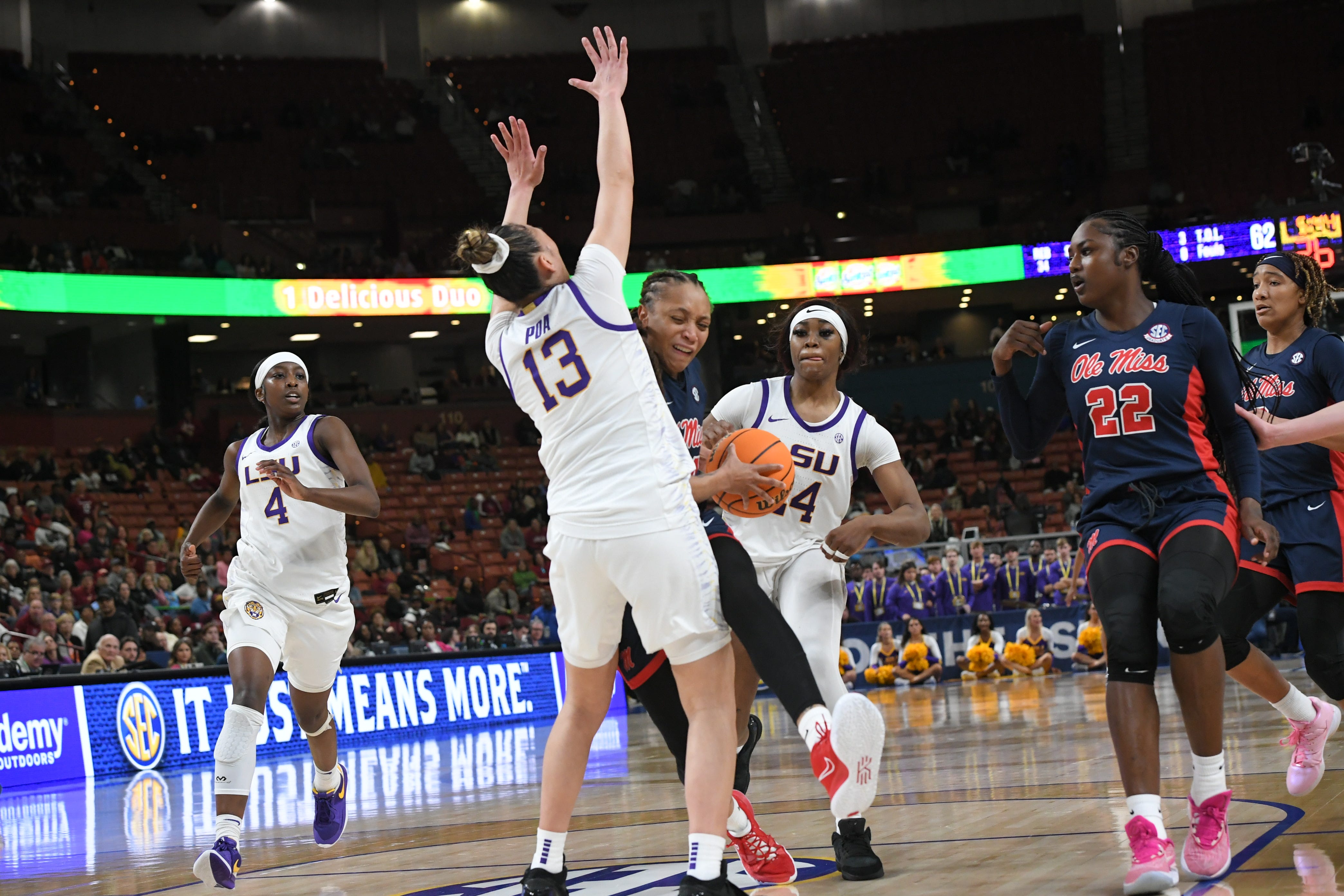 Ole Miss Madison Scott (24) shoots the ball near Louisiana State University guard Last-Tear Poa (13) falling backwards, during the fourth quarter of the SEC Women's Basketball Tournament game at the Bon Secours Wellness Arena in Greenville, S.C. Saturday, March 9, 2024.