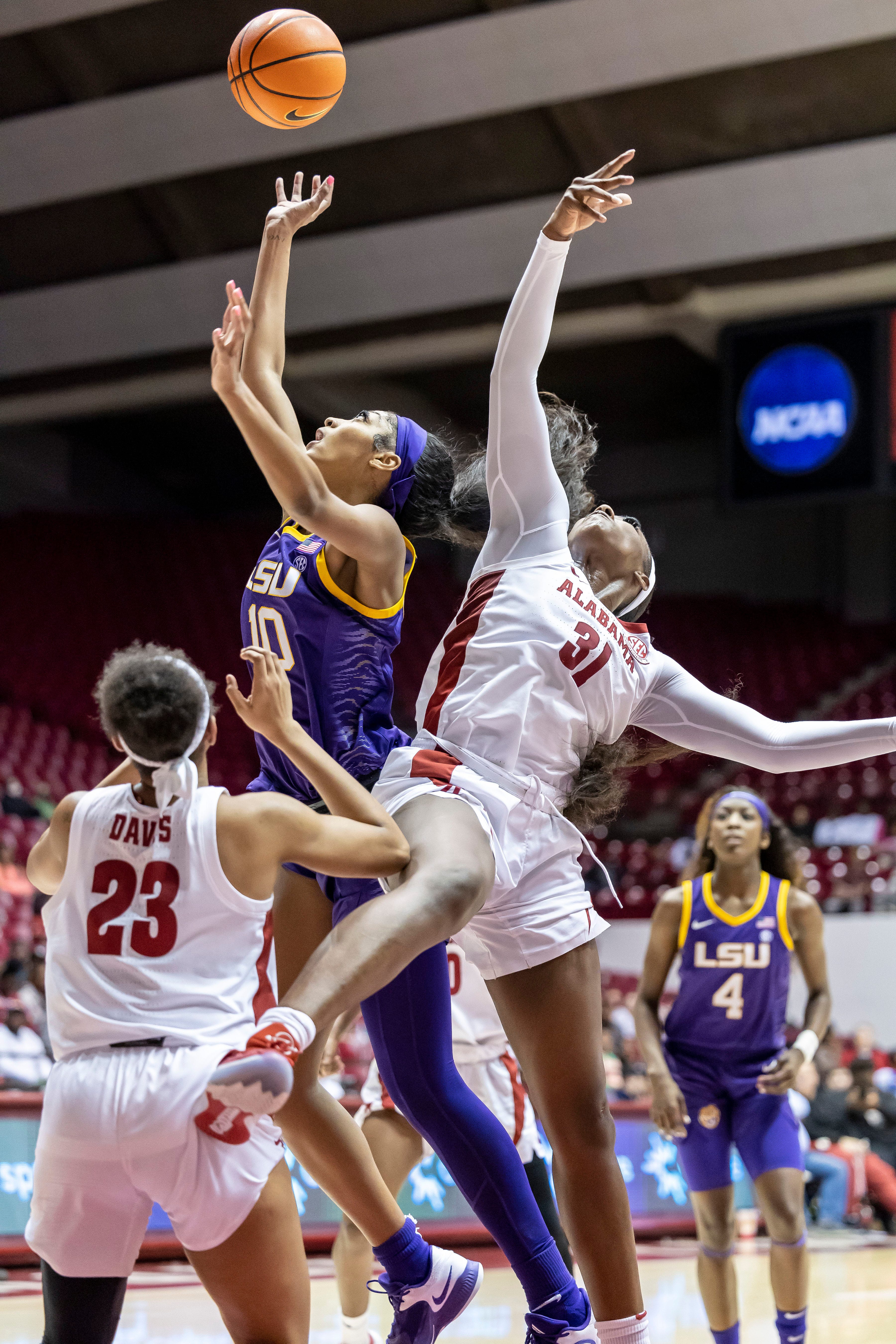 LSU forward Angel Reese (10) and Alabama center Jada Rice (31) chase a rebound during the first half of an NCAA college basketball game, Monday, Jan. 23, 2023, in Tuscaloosa, Ala. (AP Photo/Vasha Hunt)