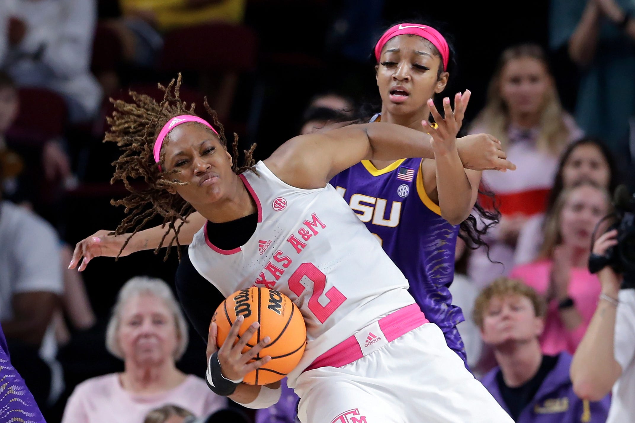 Texas A&M forward Janiah Barker, left, gets tangled up on a rebound with LSU forward Angel Reese, right, during the second half of an NCAA college basketball game, Sunday, Feb. 5, 2023, in College Station, Texas. (AP Photo/Michael Wyke)