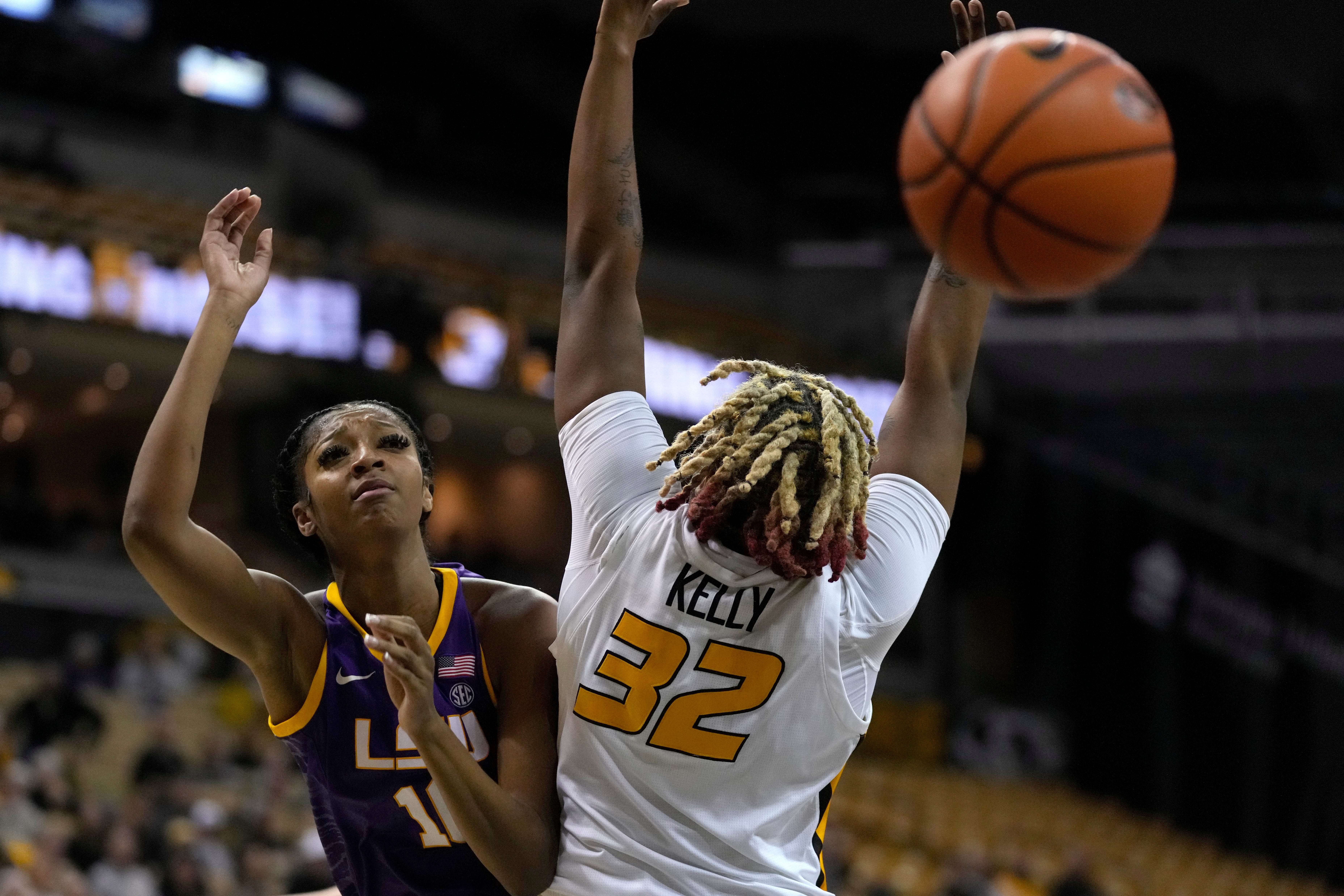 LSU's Angel Reese, left, loses the ball as she collides with Missouri's Jayla Kelly (32) during the second half of an NCAA college basketball game Thursday, Jan. 12, 2023, in Columbia, Mo. (AP Photo/Jeff Roberson)