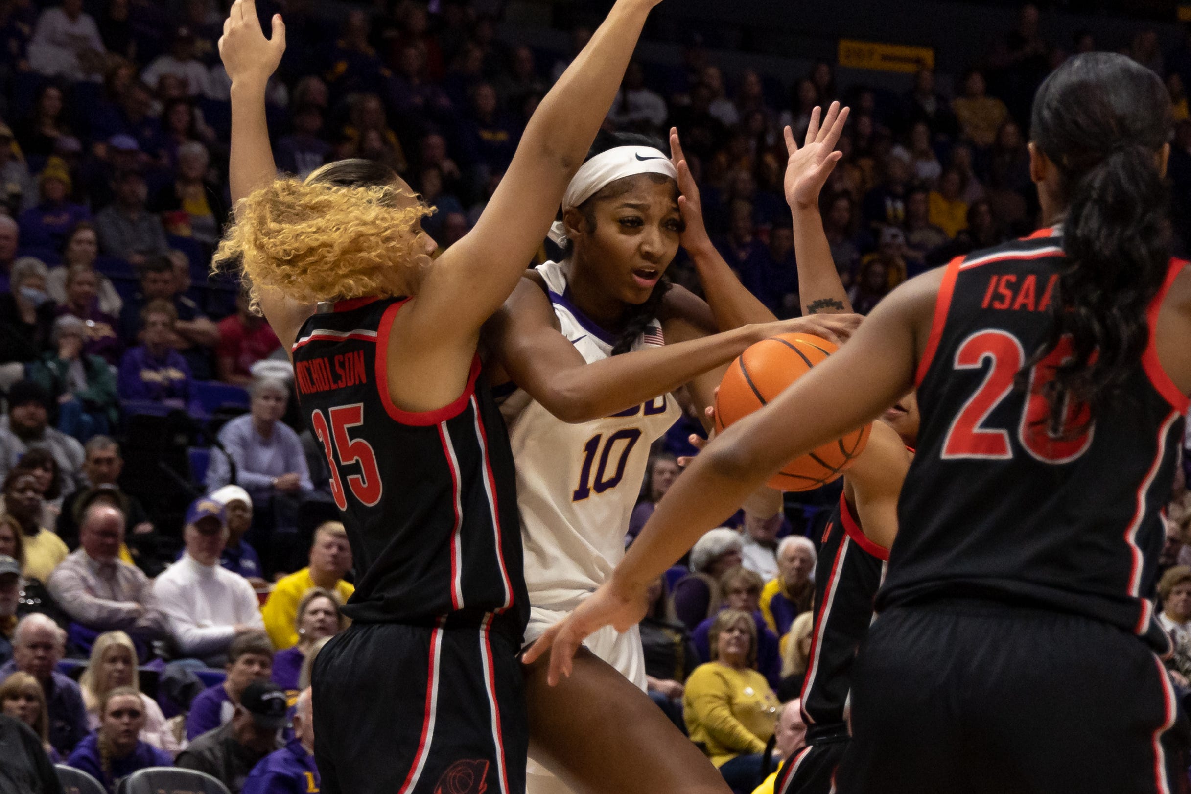 Feb 2, 2023; Baton Rouge, Louisiana, USA;  LSU Lady Tigers forward Angel Reese (10) drives through Georgia Lady Bulldogs forward Javyn Nicholson (35) during the first half at Pete Maravich Assembly Center. Mandatory Credit: Stephen Lew-USA TODAY Sports