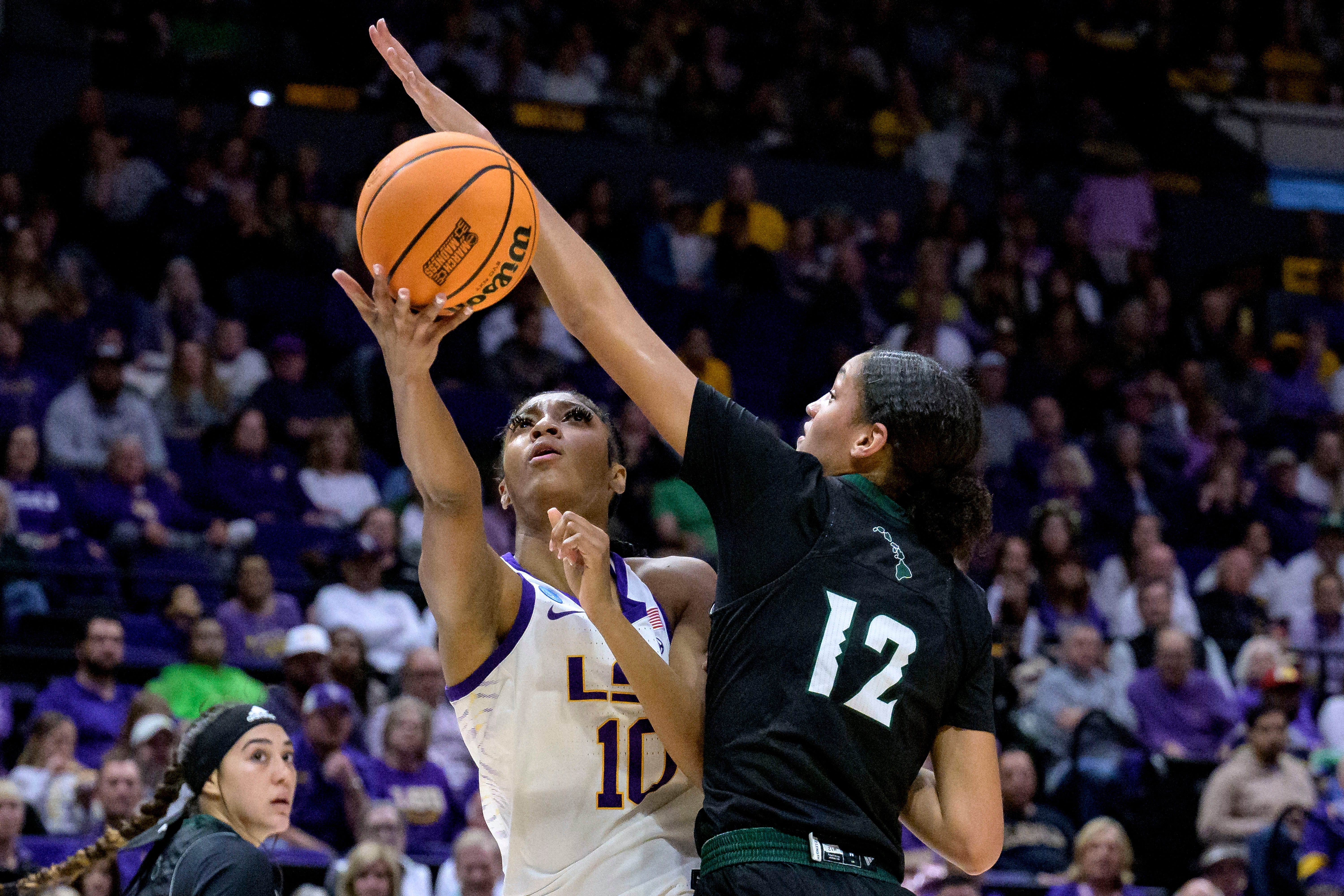 LSU forward Angel Reese (10) shoots against Hawaii forward Imani Perez (12) during the first half of a first-round college basketball game in the women's NCAA Tournament in Baton Rouge, La., Friday, March 17, 2023. (AP Photo/Matthew Hinton)