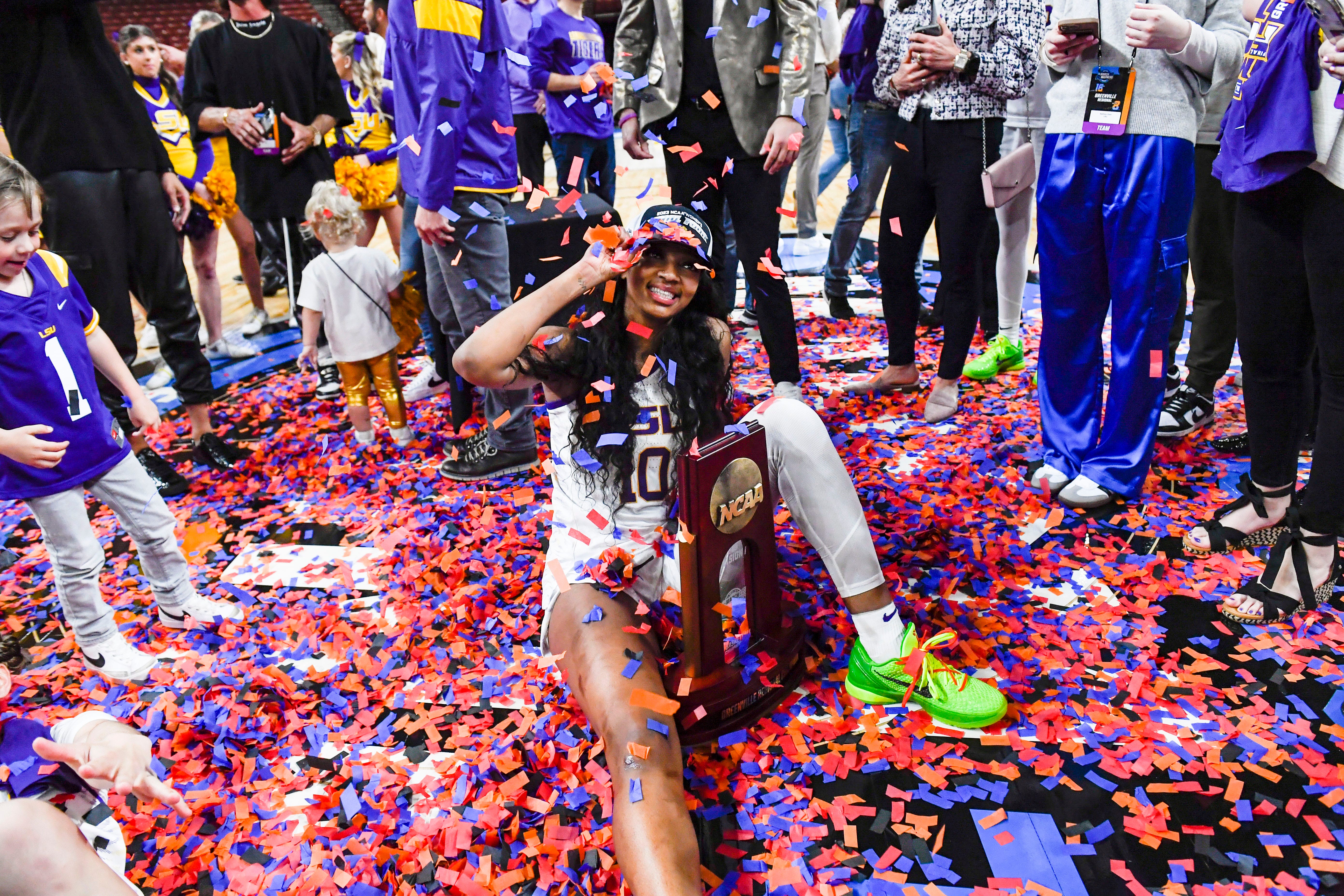 Louisiana State University forward Angel Reese (10) poses for a photo with the NCAA trophy after winning the NCAA Women's Greenville Regional Elite Eight Basketball Tournament at Bon Secours Wellness Arena in Greenville, S.C. Sunday, March 26, 2023.
