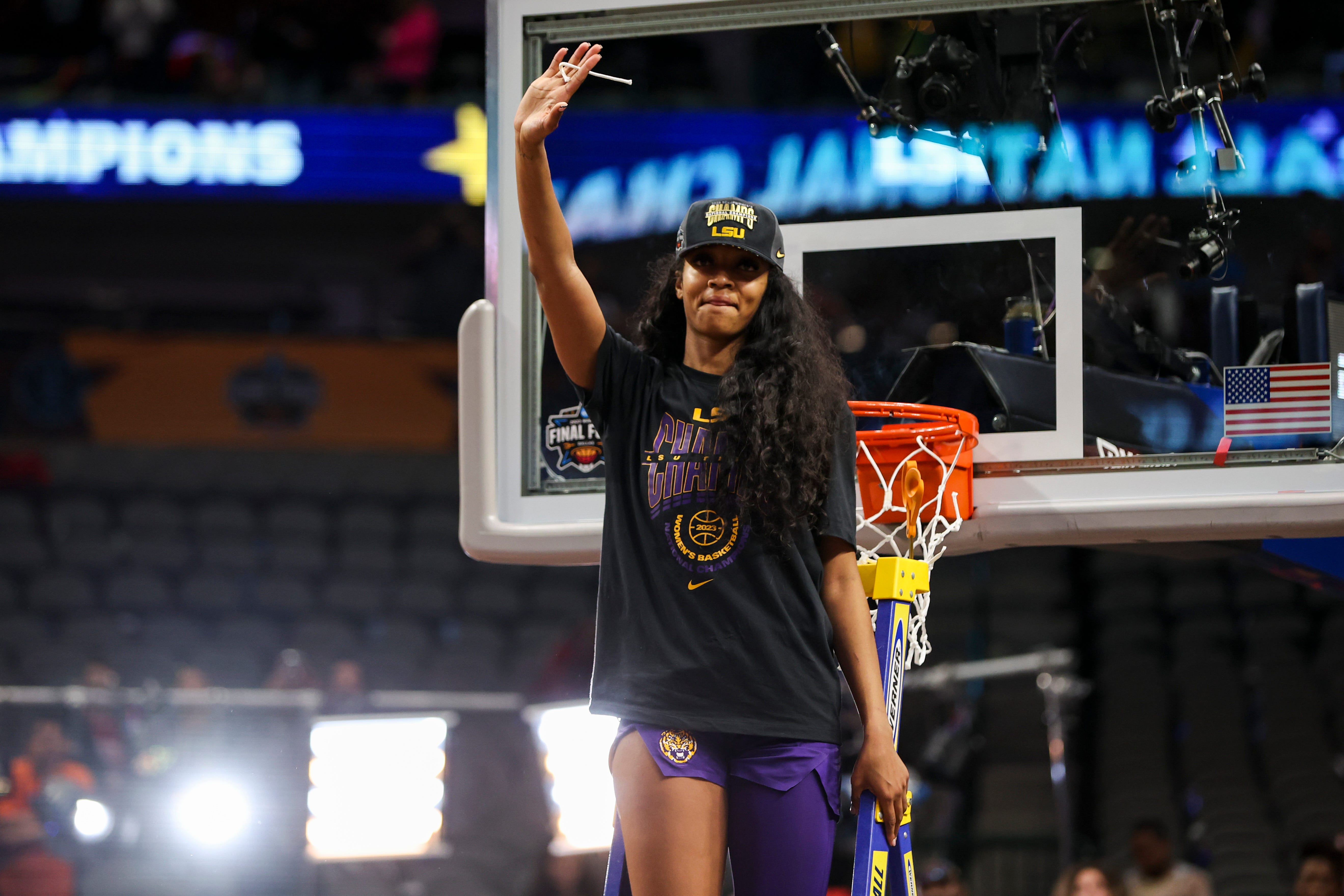 Apr 2, 2023; Dallas, TX, USA; LSU Lady Tigers forward Angel Reese (10) reacts while cutting down a piece of the net after defeating the Iowa Hawkeyes during the final round of the Women's Final Four NCAA tournament at the American Airlines Center. Mandatory Credit: Kevin Jairaj-USA TODAY Sports