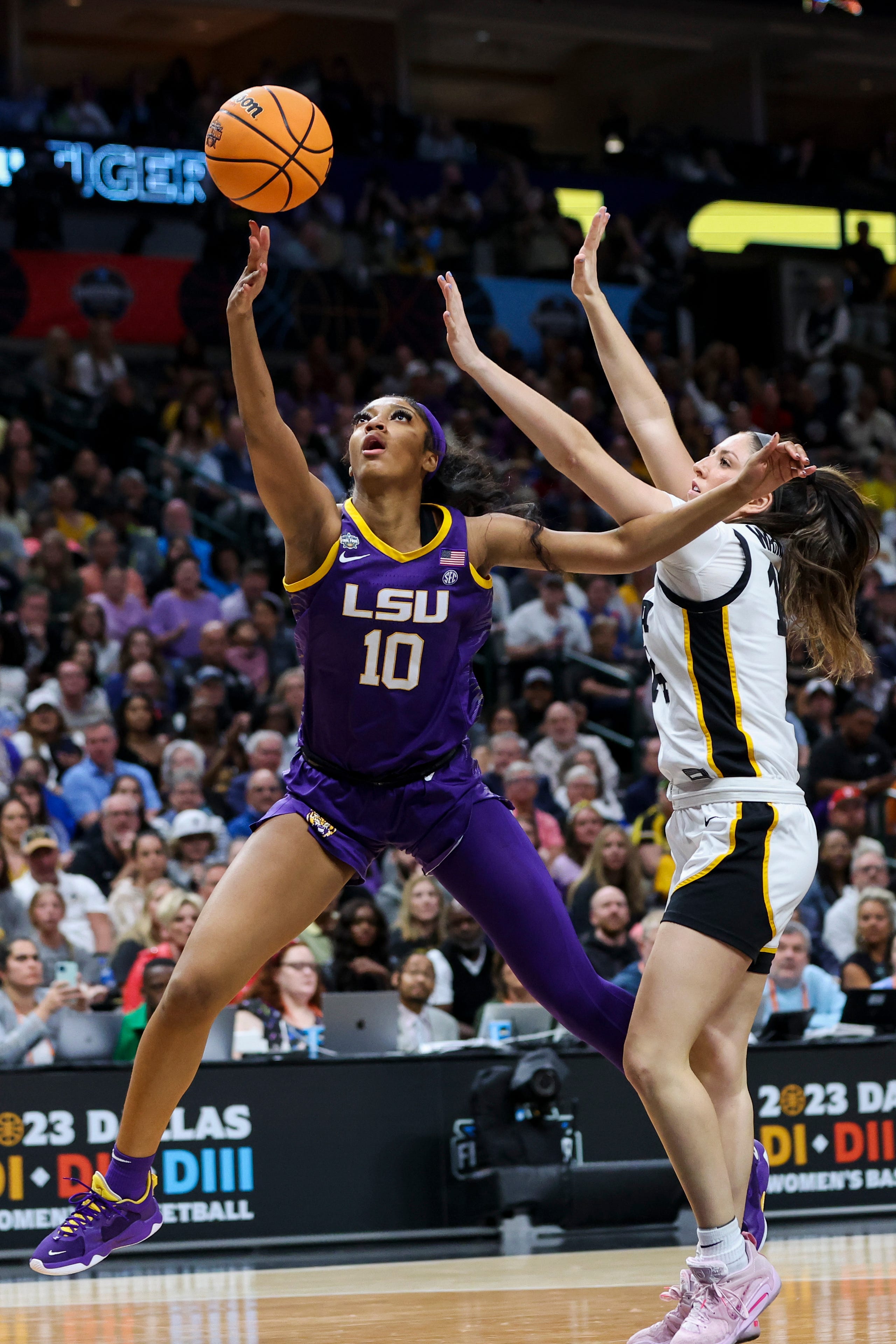 Apr 2, 2023; Dallas, TX, USA; LSU Lady Tigers forward Angel Reese (10) drives to the basket against Iowa Hawkeyes forward McKenna Warnock (14) in the first half during the final round of the Women's Final Four NCAA tournament at the American Airlines Center. Mandatory Credit: Kevin Jairaj-USA TODAY Sports